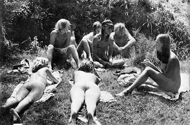 A group of young people chatting in the grass