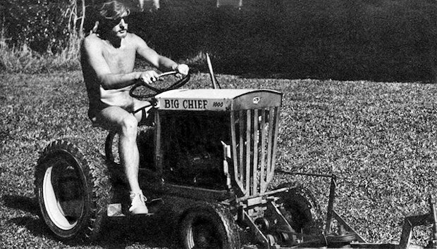 Mowing the lawn on a small tractor